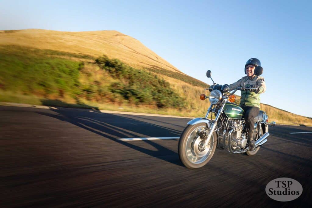 a motorcycle at speed on a road with morion blur